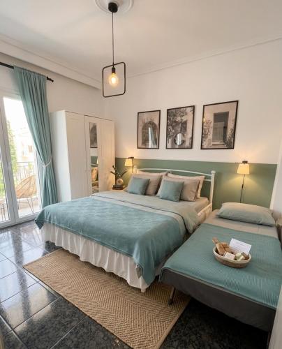 a bedroom with two beds and a large window at Dimi Guest House in Perea