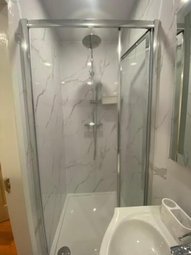 a bathroom with a shower and a sink at Standish Haven Ensuite Room in Standish