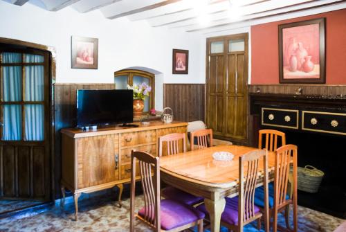a dining room with a wooden table and chairs at Casa Felix in Segura de la Sierra