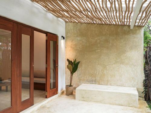 a room with a door and a plant on a wall at Studio K Ahangama in Ahangama