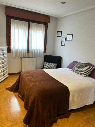 a bedroom with a large bed and a window at Avilés para Visitar in Avilés