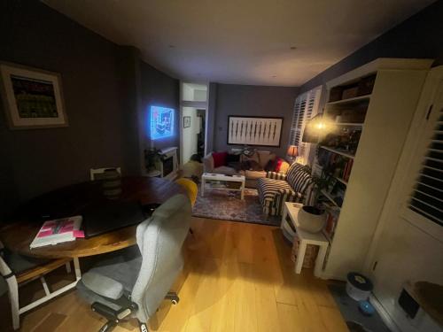 a living room with a couch and a table and chairs at Wimbledon fortnight in London