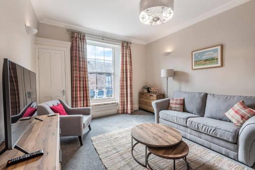 a living room with a couch and a table at Great Gate House View - within York Walls in York