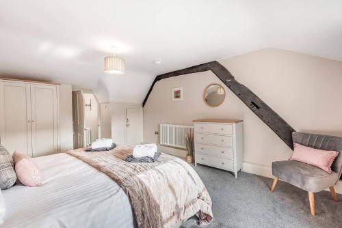 a bedroom with a large bed and a chair at Great Gate House View - within York Walls in York