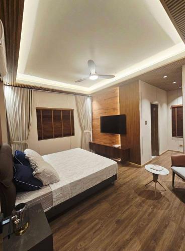 a bedroom with a bed and a flat screen tv at Villa Cassandra Atasha Private Resort - Celestine in Cuayan
