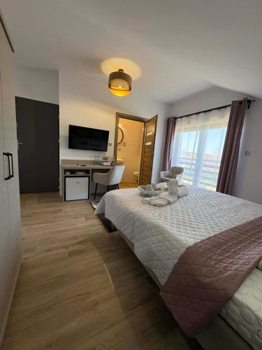 a bedroom with a bed and a desk and a television at VILLA SOLARIS Ustka - PENSJONAT Z 2026R,ROWERY GRATIS, WYPOCZYNEK tylko DLA DOROSŁYCH ! in Ustka