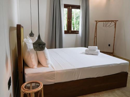 a bedroom with a bed with white sheets and pillows at Studio K Ahangama in Ahangama
