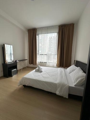 a bedroom with a bed and a large window at QH Guesthouse in Shah Alam