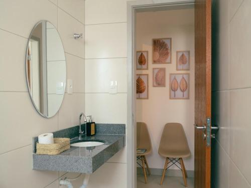 a bathroom with a sink and a mirror at Airport subway apartment in Lauro de Freitas