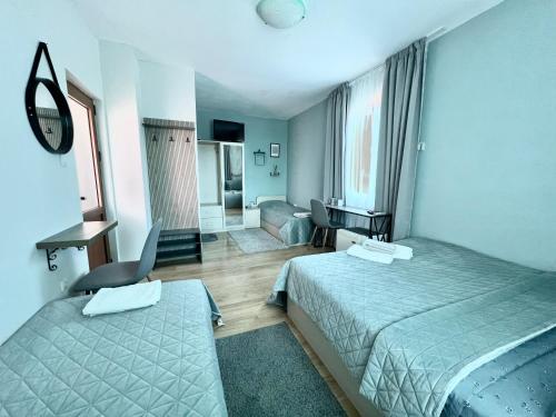 a hotel room with two beds and a desk at House Varna-3 in Krapets
