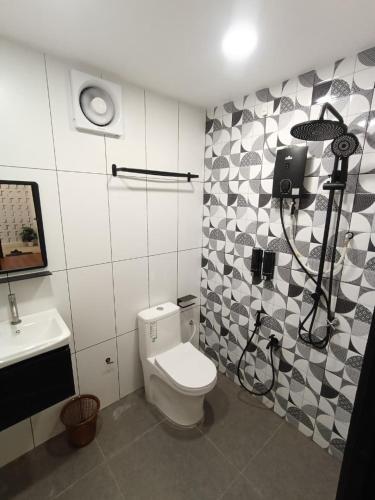 a bathroom with a toilet and a sink at Zulis Haven Stay in Kuala Rompin