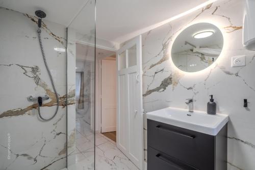a bathroom with a sink and a mirror at Studio élégant en RDC, confort et simplicité in Vaires-sur-Marne