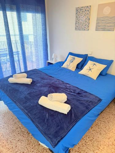 a bedroom with two beds with towels on them at Ocean Breath Home in L'Ametlla de Mar