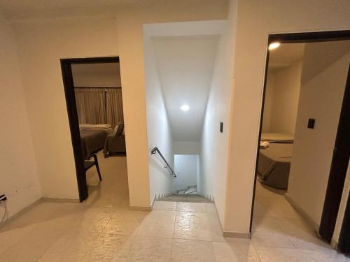 a room with a hallway with a door to a room with a room at Apartamento 201 amplio cómodo in Cali