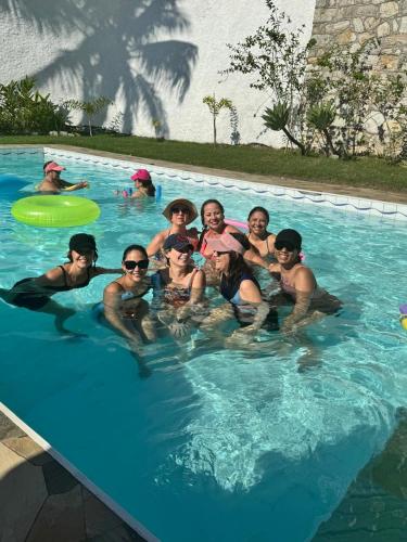 a group of people in a swimming pool at Casa das Luzes Hostel IVN in Rio de Janeiro