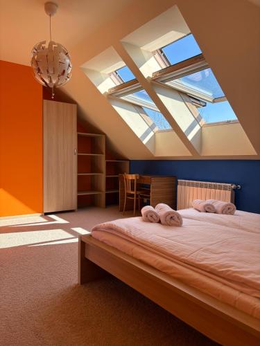 a bedroom with a bed with two towels on it at Mirabelka Mucharz in Mucharz