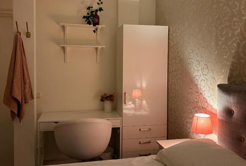 a small bedroom with a desk and a bed at Crafoord Place Hostel in Stockholm