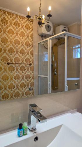 a bathroom with a mirror and a sink at Hotel Bonavista in Nuwara Eliya