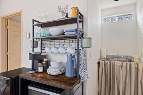 a kitchen with a shelf with dishes on it at Cresta Loft in Twain Harte