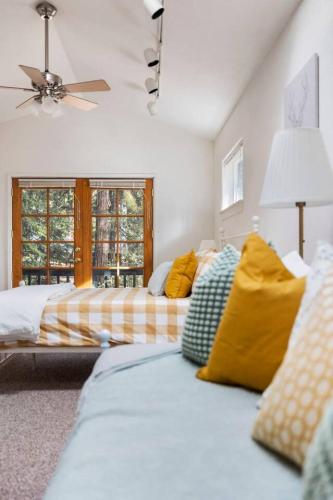 a bedroom with two beds and a ceiling fan at Cresta Loft in Twain Harte