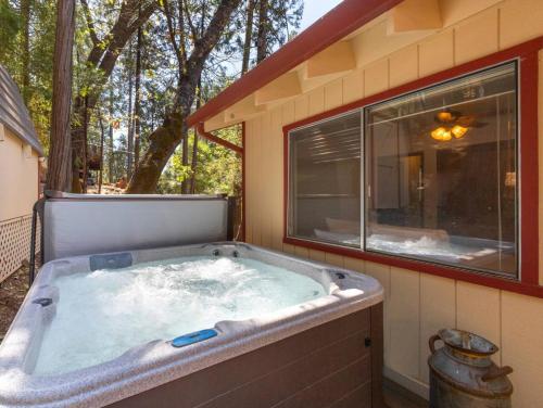 a jacuzzi tub in a house with a window at Enchanted Pines in Twain Harte