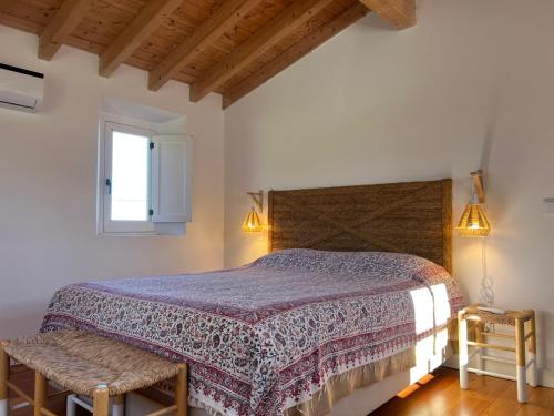 a bedroom with a large bed and a window at Marvão Country Houses - Queixos II in Santo António das Areias