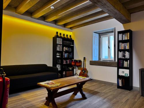 a living room with a couch and a coffee table at Albergue Santiago de Caminha in Caminha