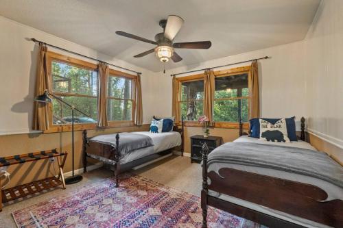 a bedroom with two beds and a ceiling fan at Hot Tub - Huge Deck - Lake Access in Twain Harte