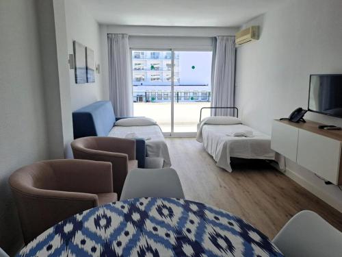 a hospital room with two beds and a window at Apartamentos Buensol in Torremolinos