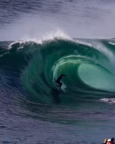 a person riding a wave on a surfboard in the ocean at Casa Marina in Lajares