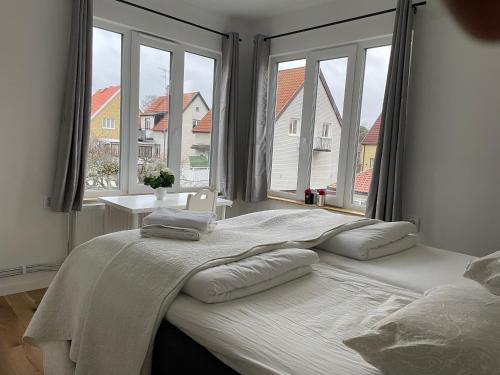 a bed in a bedroom with a large window at Ruddbecksgatan AA in Eskilstuna