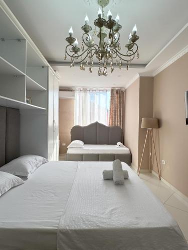 a bedroom with a bed with a stuffed animal on it at Edion Center Apartment in Shkodër