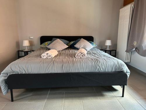 a bedroom with a bed with two pillows at Appartamento Ca' Mia in Montà