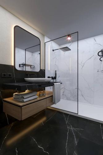 a bathroom with a sink and a mirror at Almaris Resort in Alanya