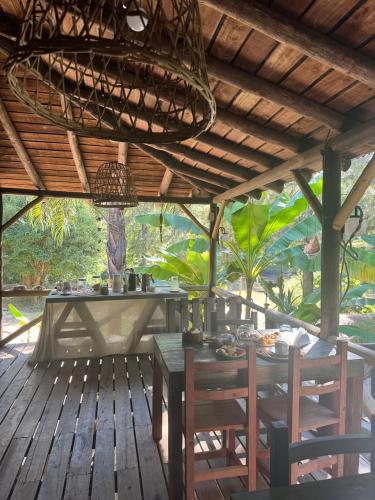 a dining room with a table and chairs on a wooden deck at Cabañas Allende Delta in Tigre