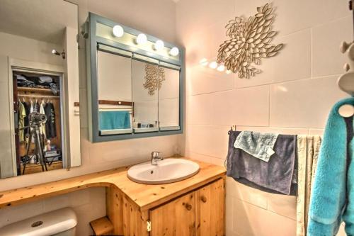 a bathroom with a sink and a mirror at Beachfront Studio in Marigot in Marigot