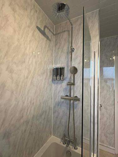 a shower in a bathroom with a sink at Bright Harrogate flat 2 beds great location in Harrogate