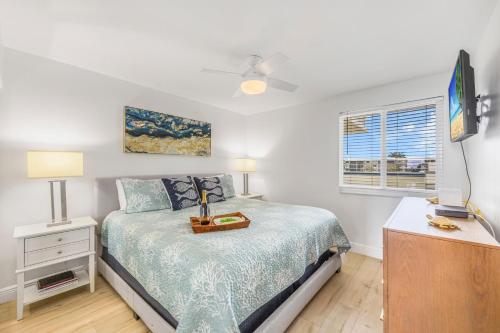 a bedroom with a bed and a dresser and a tv at Apollo 207 in Marco Island