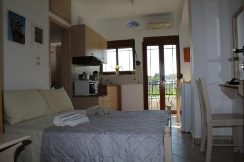 a bedroom with a bed with towels on it at Vakis Apartments 2 in Romanón