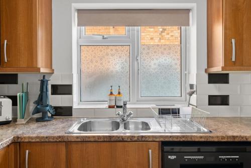a kitchen with a sink and a window at 5-Bed Family & Group Stay Near Cricket Ground in Worcester