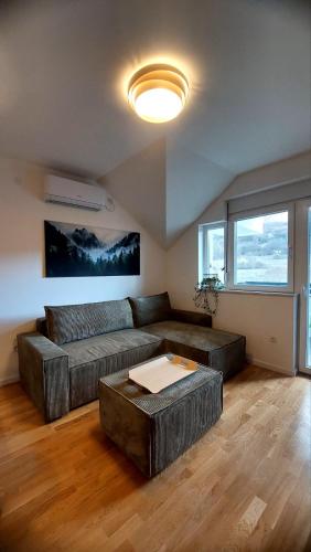 a living room with a couch and a table at My Life 19 - Green Hill in Soko Banja