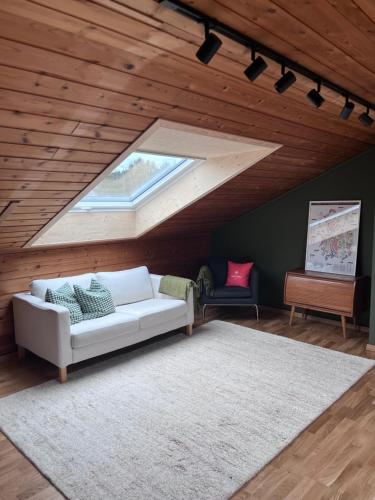 a living room with a white couch and a window at 2 minute walk from ONS exhibiton area in Stavanger