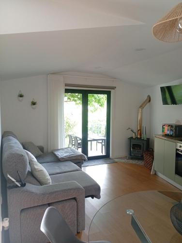 a living room with two couches and a fireplace at Refúgio Da Pinheira in Marco de Canaveses