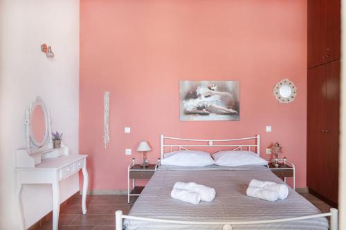 a bedroom with a bed with two towels on it at Oliva Mare I in Agia Fotia