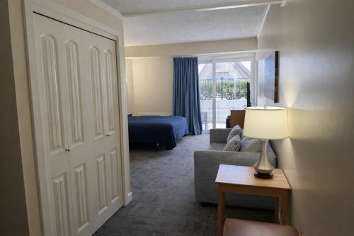 a living room with a couch and a bed at Courtyard Resort in Hyannis