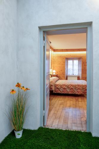 an open door to a room with a bed and a window at Oasi del relax in Scopello