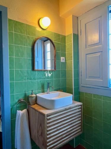 a bathroom with a sink and a mirror at Casa Terra in Rio Maior