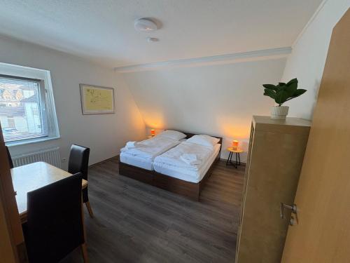 a bedroom with a bed and a table and a table sidx sidx sidx at Ferienhaus in Marl