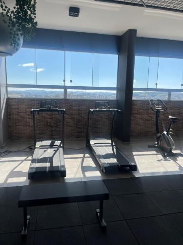 a gym with two chairs and a table in a building at Studio Aura in Barbacena