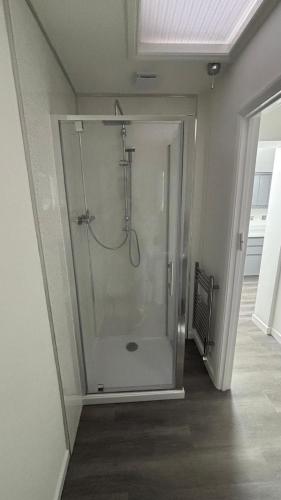 a bathroom with a shower with a glass door at Newly refurbished Annexe in Wareham